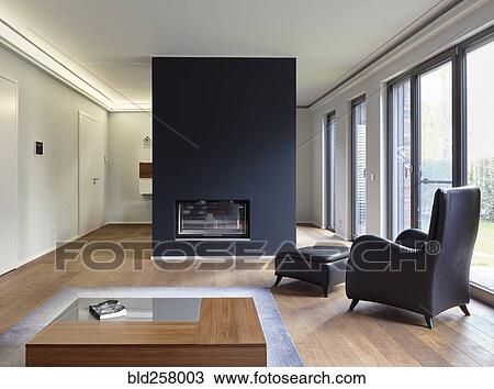 Stock Image - Plank floor and modern fireplace in home. Fotosearch