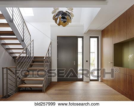 Stock Photo - Plank floor and walnut wall covering in home near staircase. Fotosearch