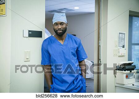 Portrait of a black nurse leaning in doorway View Large Photo Image Stock Photo - Portrait of a black nurse leaning in doorway. Fotosearch