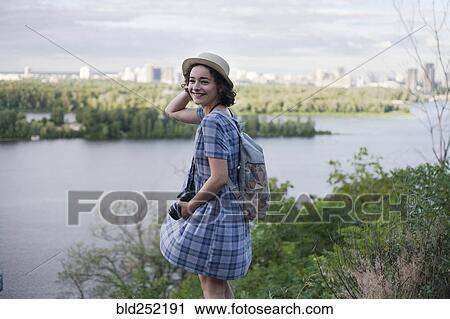 Portrait of a Caucasian woman carrying camera near river View Large Photo Image Stock Image - Portrait of a Caucasian woman carrying camera near river. Fotosearch