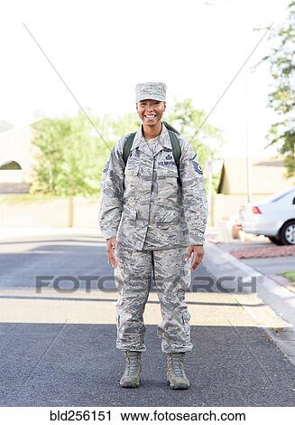 Stock Image - Portrait of black woman soldier standing in street. Fotosearch