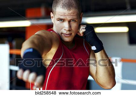 Stock Photo - Portrait of Caucasian boxer punching. Fotosearch