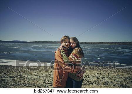 Portrait of Caucasian couple hugging on beach View Large Photo Image Stock Photo - Portrait of Caucasian couple hugging on beach. Fotosearch