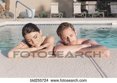 Picture - Portrait of Caucasian couple relaxing in swimming pool. Fotosearch