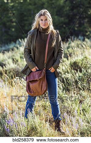 Stock Photo - Portrait of Caucasian girl standing in wildflowers. Fotosearch
