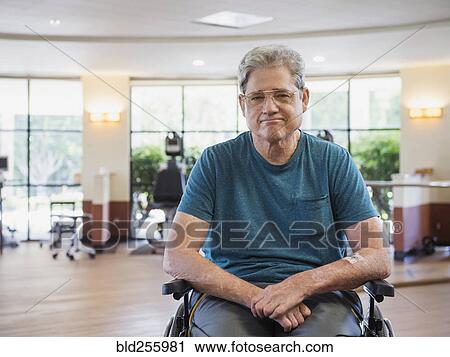 Stock Image - Portrait of Caucasian man sitting in wheelchair. Fotosearch