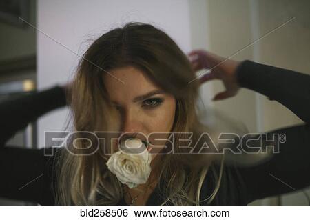 Portrait of Caucasian woman biting flower View Large Photo Image Stock Photograph - Portrait of Caucasian woman biting flower. Fotosearch
