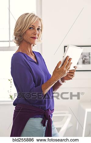 Portrait of Caucasian woman holding digital tablet View Large Photo Image Stock Photograph - Portrait of Caucasian woman holding digital tablet. Fotosearch