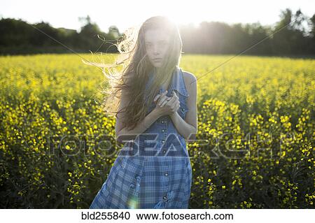 Portrait of Caucasian woman standing in windy field View Large Photo Image Stock Image - Portrait of Caucasian woman standing in windy field. Fotosearch