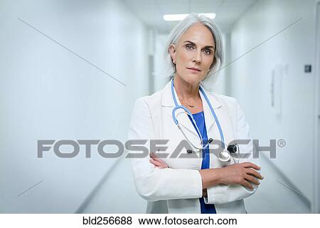 Stock Photo - Portrait of confident Caucasian doctor in hospital. Fotosearch
