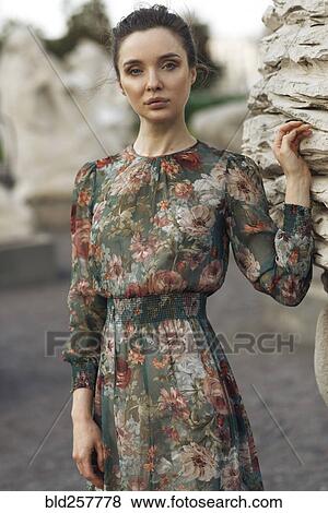 Portrait of confident Caucasian woman leaning on statue View Large Photo Image Stock Photo - Portrait of confident Caucasian woman leaning on statue. Fotosearch
