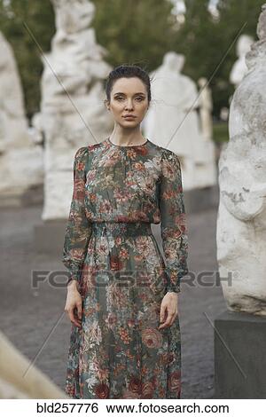 Portrait of confident Caucasian woman standing near statues View Large Photo Image Stock Photograph - Portrait of confident Caucasian woman standing near statues. Fotosearch