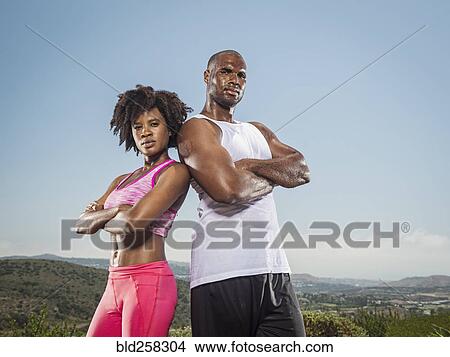Portrait of confident sweating Black couple standing in landscape View Large Photo Image Picture - Portrait of confident sweating Black couple standing in landscape. Fotosearch