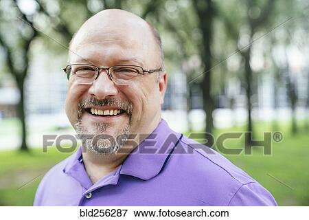 Portrait of laughing Caucasian man in park View Large Photo Image Stock Photo - Portrait of laughing Caucasian man in park. Fotosearch