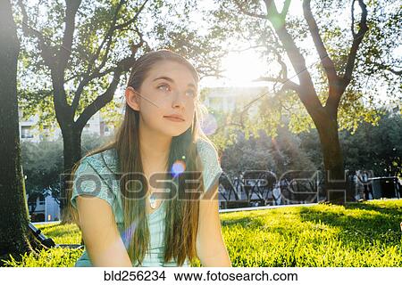 Picture - Portrait of pensive Caucasian girl in park. Fotosearch