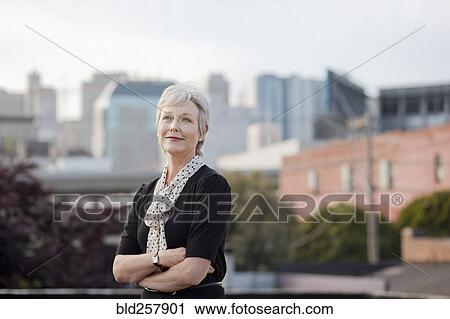 Stock Image - Portrait of pensive Caucasian businesswoman posing outdoors. Fotosearch