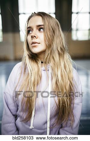 Stock Image - Portrait of pensive Caucasian woman in gymnasium. Fotosearch