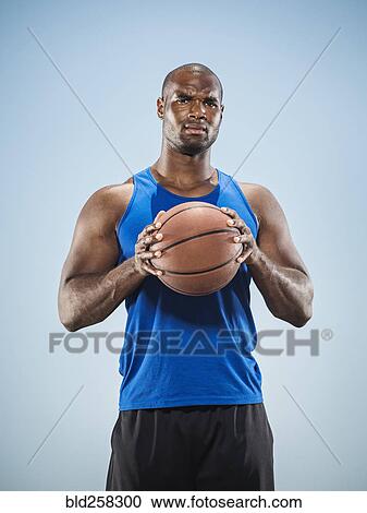 Portrait of serious Black man holding basketball View Large Photo Image Stock Image - Portrait of serious Black man holding basketball. Fotosearch