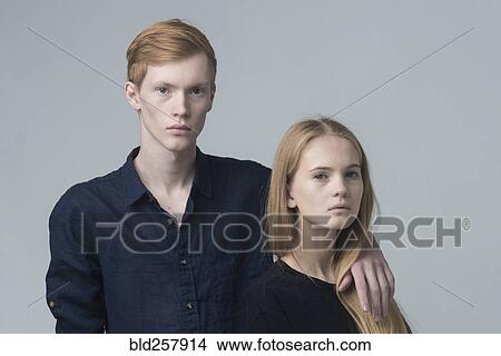 Picture - Portrait of serious Caucasian couple hugging. Fotosearch