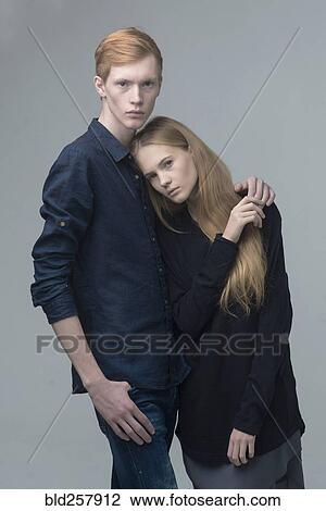 Portrait of serious Caucasian couple hugging View Large Photo Image Stock Image - Portrait of serious Caucasian couple hugging. Fotosearch