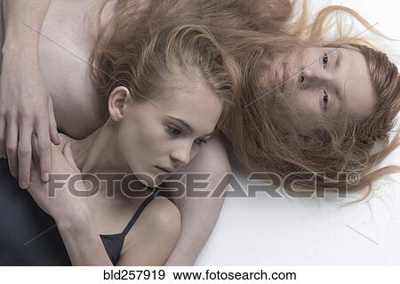 Stock Photo - Portrait of serious Caucasian couple relaxing. Fotosearch