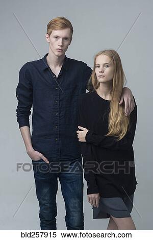 Stock Photography - Portrait of serious Caucasian couple hugging. Fotosearch