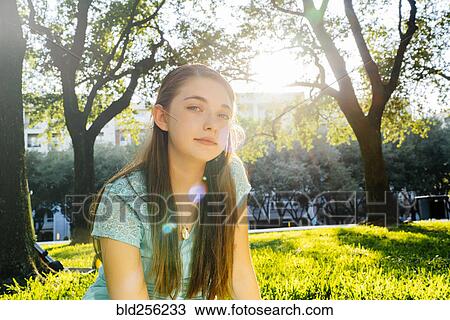 Portrait of serious Caucasian girl in park View Large Photo Image Stock Image - Portrait of serious Caucasian girl in park. Fotosearch