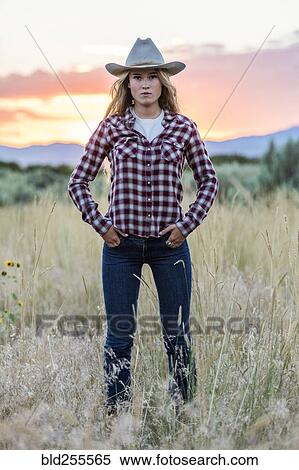 Portrait of serious Caucasian teenage girl wearing cowboy hat at sunset View Large Photo Image Stock Photography - Portrait of serious Caucasian teenage girl wearing cowboy hat at sunset. Fotosearch