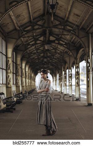 Stock Photo - Portrait of serious Caucasian woman at train station. Fotosearch