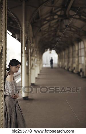 Stock Photo - Portrait of serious Caucasian woman at train station. Fotosearch