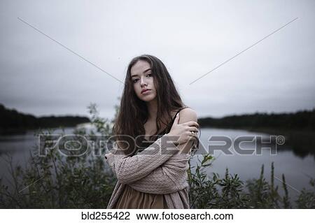 Portrait of serious Caucasian woman standing near a river View Large Photo Image Stock Image - Portrait of serious Caucasian woman standing near a river. Fotosearch