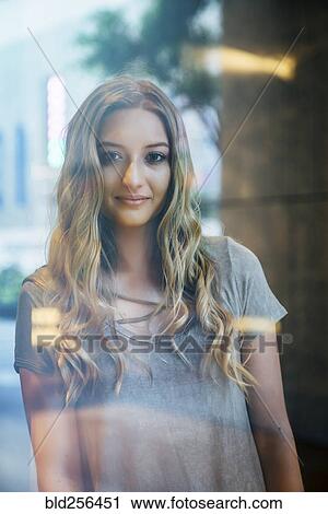 Portrait of serious Caucasian woman behind window View Large Photo Image Stock Image - Portrait of serious Caucasian woman behind window. Fotosearch