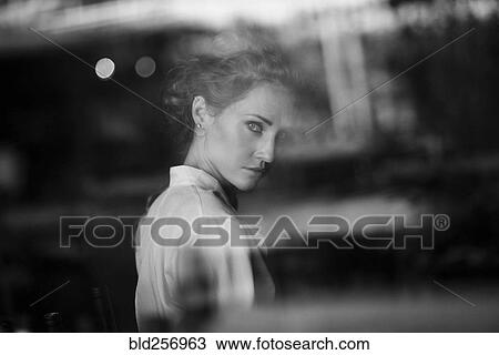 Portrait of serious Caucasian woman behind window View Large Photo Image Stock Image - Portrait of serious Caucasian woman behind window. Fotosearch