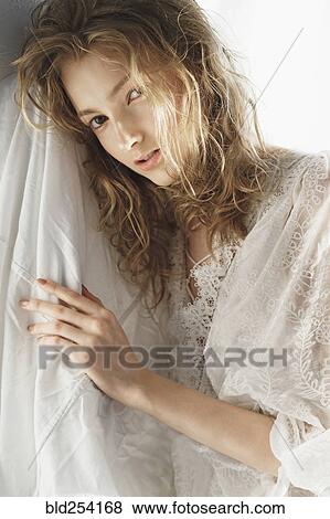 Portrait of serious Caucasian woman leaning on sheet View Large Photo Image Stock Photo - Portrait of serious Caucasian woman leaning on sheet. Fotosearch