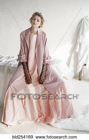 Portrait of serious Caucasian woman wearing pink dress View Large Photo Image Stock Photo - Portrait of serious Caucasian woman wearing pink dress. Fotosearch