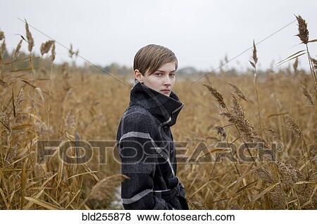 Portrait of serious Caucasian woman standing in field View Large Photo Image Stock Photo - Portrait of serious Caucasian woman standing in field. Fotosearch