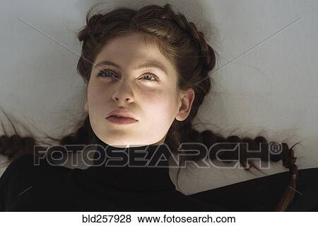 Stock Photo - Portrait of serious Caucasian woman looking up. Fotosearch