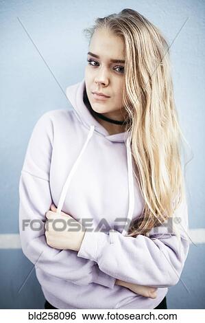 Stock Photograph - Portrait of serious Caucasian woman wearing hoodie. Fotosearch