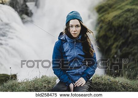 Portrait of serious Caucasian woman sitting near waterfall View Large Photo Image Stock Photography - Portrait of serious Caucasian woman sitting near waterfall. Fotosearch