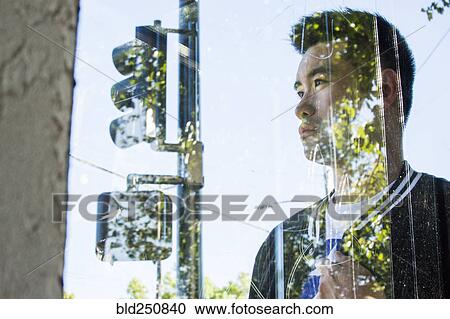 Portrait of serious Chinese man behind window View Large Photo Image Stock Image - Portrait of serious Chinese man behind window. Fotosearch