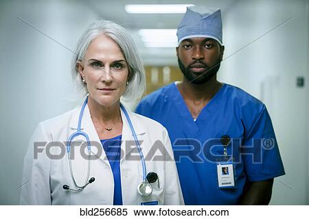 Stock Photography - Portrait of serious doctor and nurse. Fotosearch