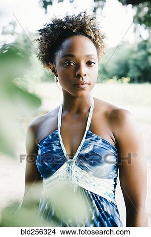 Picture - Portrait of serious mixed race woman outdoors. Fotosearch
