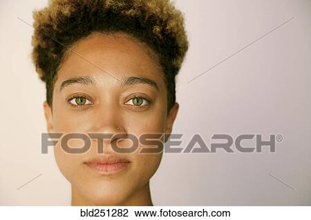 Stock Image - Portrait of serious mixed race woman. Fotosearch