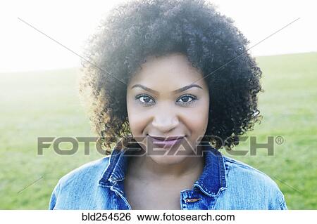 Stock Photograph - Portrait of serious mixed race woman. Fotosearch