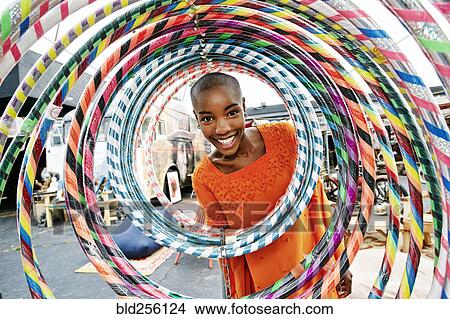 Portrait of smiling bald black woman behind hoops View Large Photo Image Picture - Portrait of smiling bald black woman behind hoops. Fotosearch