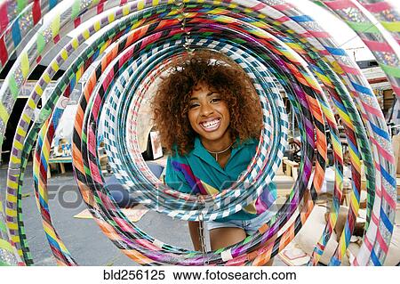 Portrait of smiling black woman behind hoops View Large Photo Image Stock Photography - Portrait of smiling black woman behind hoops. Fotosearch