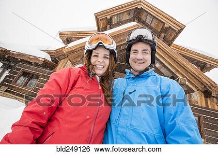 Stock Photograph - Portrait of smiling Caucasian couple on winter vacation. Fotosearch