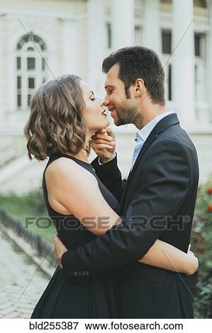 Portrait of smiling Caucasian couple kissing View Large Photo Image Stock Photo - Portrait of smiling Caucasian couple kissing. Fotosearch