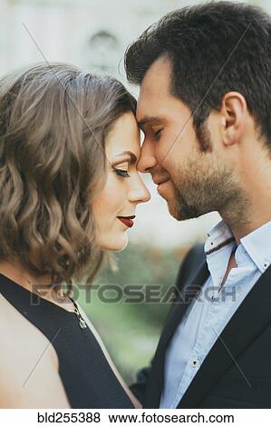 Stock Photo - Portrait of smiling Caucasian couple touching faces. Fotosearch