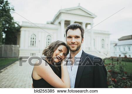 Stock Photography - Portrait of smiling Caucasian couple hugging. Fotosearch